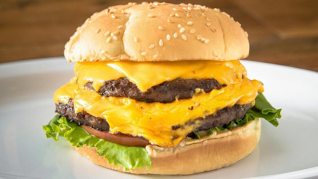 Double Cheese · Two 1/4 lb Natural Beef Patties,  2 slices of american cheese, lettuce, tomato, onion, pickle and house Sauce on a Sesame Bun.