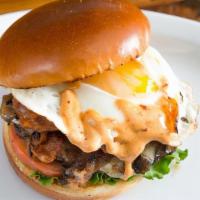Storm · 1/4 lb Natural Beef Patty, fried egg, 2 strips of bacon, caramelized onions, swiss cheese, l...