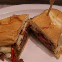 Steak Supreme · Thinly sliced prime beef steak topped with sautéed onions, mushrooms, sweet red peppers & me...
