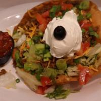 South Of Boarder · A crisp Tortilla shell lined with beans, filled with crisp lettuce, seasoned beef, fresh tom...