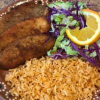 Filete Empanizado · Breaded tilapia fillet fish served with salad, rice, and refried beans.