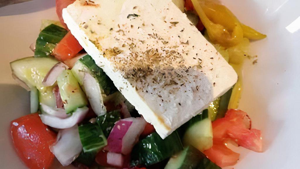 Greek Salad · Mixed greens with cucumber, tomato, onion, black olives, and feta cheese.