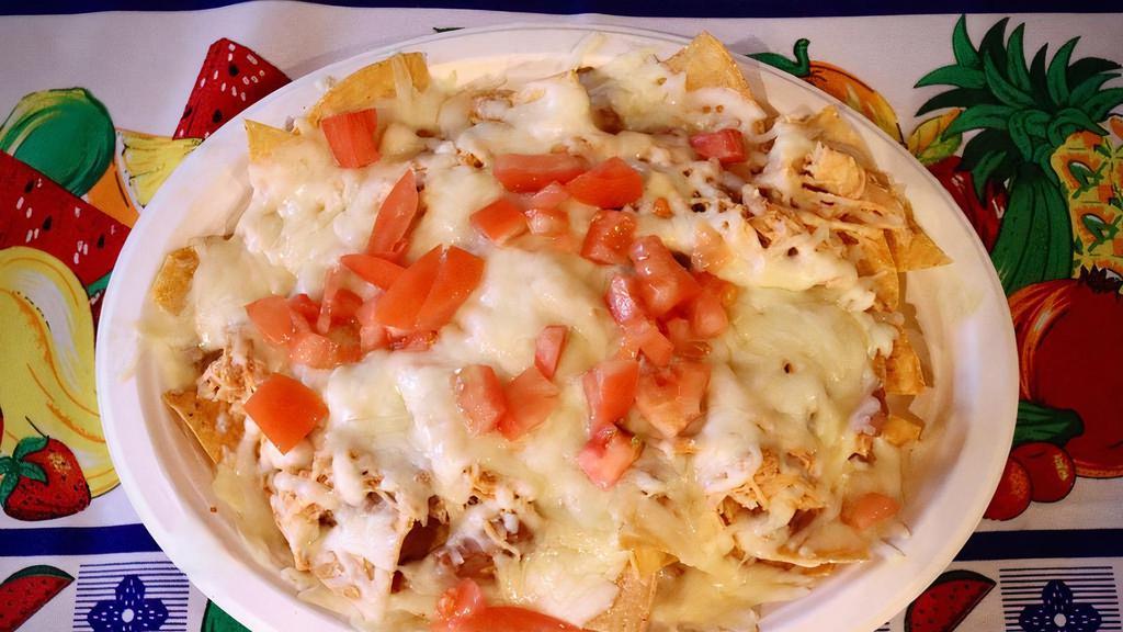 Senor Villa Nachos · Tortillas chips, beans, topped with melted cheese, your choice of meat (chicken, ground beef or shredded beef) sour cream and tomatoes.
