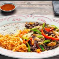 Carnitas De Res · Steak strips cooked and mixed with onions, mushrooms, bell pepper, and tomato. Served with r...