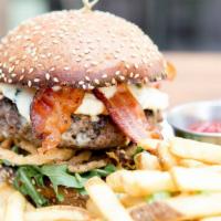 Blue Bacon Burger · Crispy bacon,  fried onion strings, shredded lettuce, sliced tomato, bleu cheese dressing.

...
