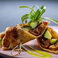 Duck Roll · Chopped duck wrapped in crispy roti with cucumber, red bell, green onions and special duck s...
