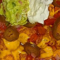 Loaded Tater Tots · Basket of deep fried tater tots drizzled with nacho cheese and topped with choice of beef or...