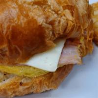 Ham Cheese And Egg Croissant · Sliced, grilled ham with scrambled eggs and your choice of cheese on a buttered croissant an...