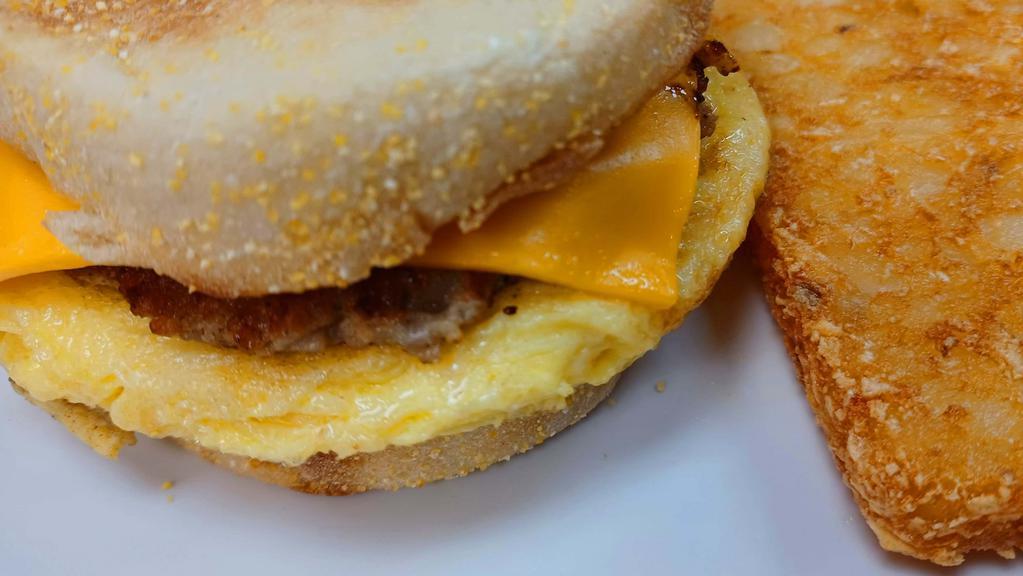 Sausage And Egg Sandwich · Toasted English muffin with a sausage patty, scrambled eggs and your choice of cheese served with a patty of hash browns