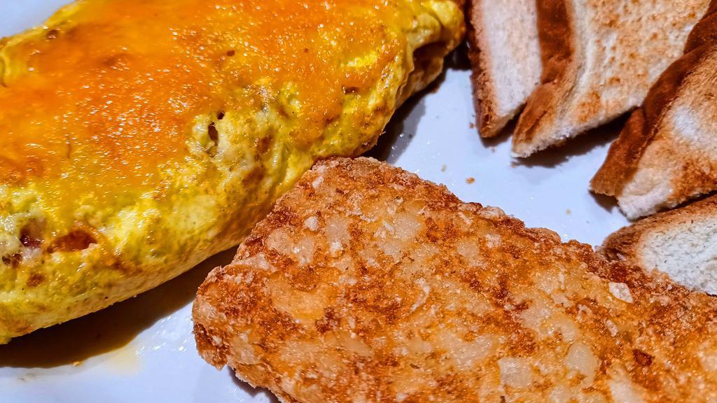 Farmers Omelette Combo · 3 egg omelette with bacon, onions, tomatoes and choice of cheese.  Served with either sausage patties or bacon strips, a deep fried hash brown patty or country potatoes and your choice of toast.
