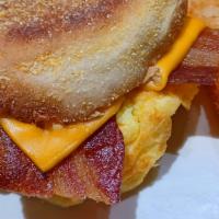 Bacon And Egg English Muffin · Toasted English muffin with slices of bacon, scrambled eggs and your choice of cheese served...