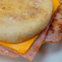 Ham And Egg English Muffin · Toasted English muffin with sliced ham, scrambled eggs and your choice of cheese, served wit...