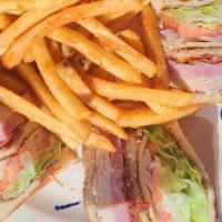 Madison'S Club Sandwich · Traditional club sandwich layered with ham, turkey, bacon, tomatoes and red onions on white ...