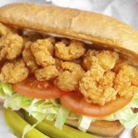 Shrimp Po'Boy Sandwich · Crispy popcorn shrimp on herbed lettuce with tomato chunks and remoulade sauce on a Toasted ...