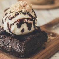 Rich Chocolate Brownie With Ice Cream · Rich chocolate brownie with chocolate chunks and vanilla ice cream on the side.