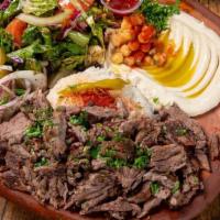 Beef Shawarma Plate · A generous portion of our marinated meat slices. Served with side of hummus, salad and rice.