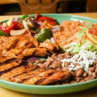 Pollo Asado · Marinated chicken breast char-broiled to perfection. Served with rice and whole beans. Garni...