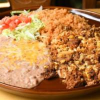Huevos Con Chorizo · Our homemade pork Mexican sausage scrambled with eggs. Served with Mexican rice and refried ...