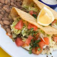 Fish Taco Dinner · Two blue corn encrusted white fish soft tacos with cabbage, and tomatoes, side of rice and b...