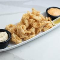 Crispy Calamari · Lightly fried calamari rings dusted with a roasted garlic pepper semolina breading served wi...