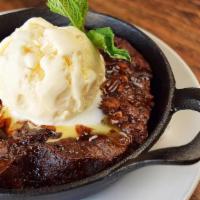 Deep Dish Chocolate Brownie · Double chocolate porter brownie with pecans, caramel and chocolate fudge sauces, baked in a ...