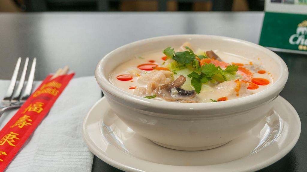 #22. Tom Kha (Coconut) · A traditional Thai coconut soup, with fresh mushrooms, tomatoes, onions and Thai herbs with choice of meat.