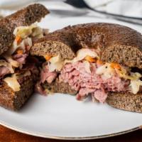 Reuben · Corned beef, swiss, sauerkraut and russians dressing. Served with fresh pickle spear.