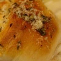 Garlic Knots · Hand-tied Italian bread drizzled with garlic butter, Parmesan, and herbs. With a side of mar...