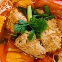 #52. Bun Rieu · Crab noodle soup. Seafood broth with crab, cubed pork blood, tofu, pork meatballs, tomatoes ...