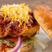 Vegetarian Chili Beyond Burger · A Beyond Burger placed on a soft, toasted brioche bun, topped with melted cheddar cheese, to...