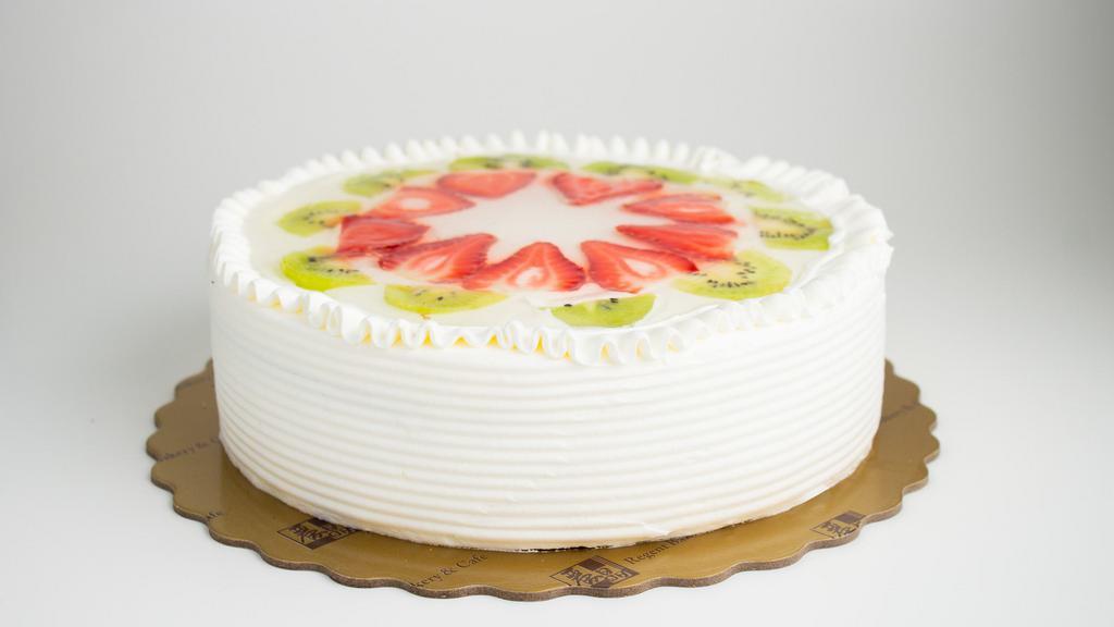 Fruit Cake · Light chiffon cake layered with fresh fruits (honey dew, cantaloupe and pineapple). With strawberries and kiwis on top.
