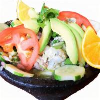 Molcajete De Mariscos · Ceviche style shrimp, octopus, scallops, aguacate, orange slice, avocado, tomatoes, purple o...