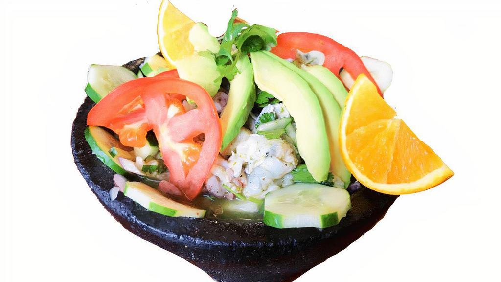 Molcajete De Mariscos · Ceviche style shrimp, octopus, scallops, aguacate, orange slice, avocado, tomatoes, purple onions and served cold. Served with tortilla chips, toast, and crackers.