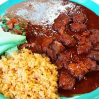 Chile Colorado · Chunks of pork in a red sauce with a unique house’s recipe. Served with rice, beans, and sal...