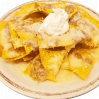 Kids' Nachos · Nachos served with cheese, beans, sour cream and your choice of meat.