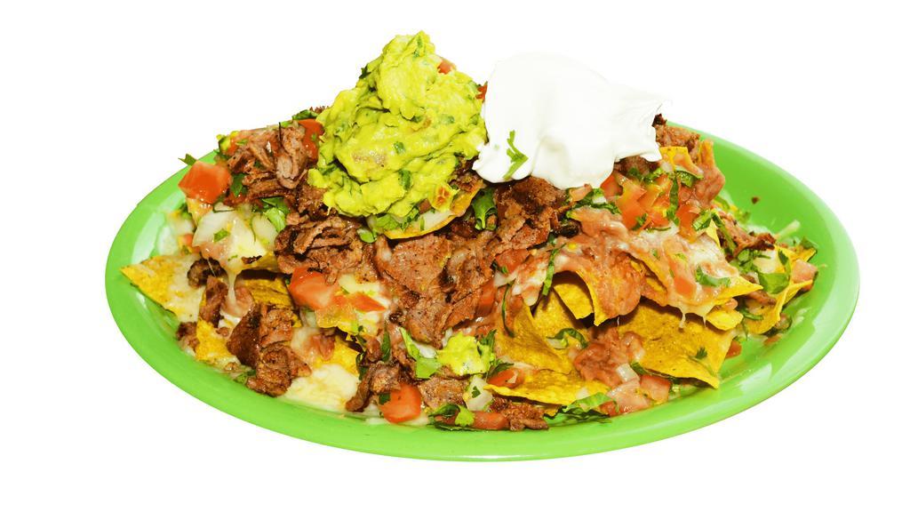 Meat Nachos · Crispy nachos served with melted cheese, refried beans, pico de gallo, sour cream, guacamole, and your choice of meat.