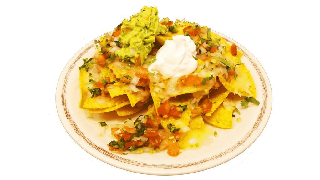 Nachos Without Meat · Crispy nachos served with melted cheese, refried beans, pico de gallo, sour cream, and guacamole.