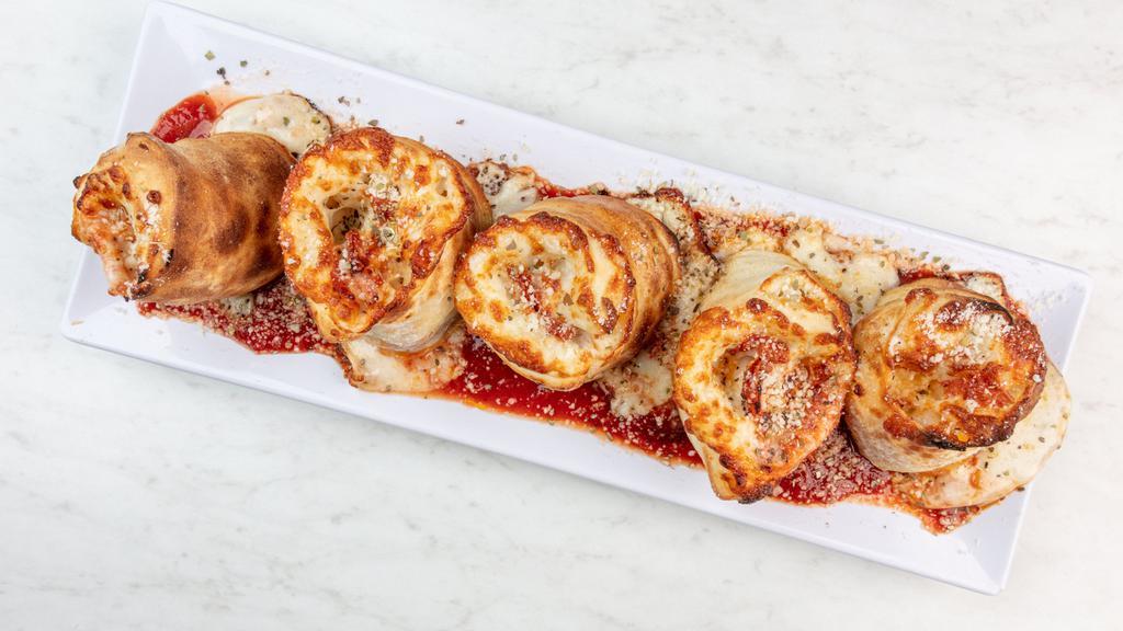 Pepperoni Rollatini · House-made dough rolled with pepperoni, pizza sauce, mozzarella and a sprinkle of parmesan baked and served five to an order with house-made red sauce.