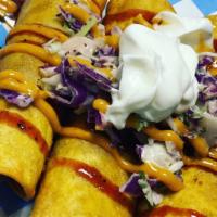 Texas Taquitos · 3 Texas Taquitos filled with your choice of meat, topped with our Texas Jalapeño Slaw, BBQ S...