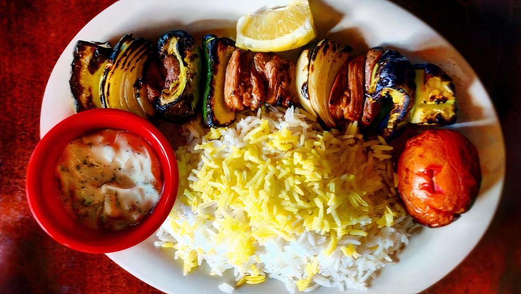 Babajoon'S Lamb Shish Kabob · Marinated tender lamb chunks with zucchini, onion, bell peppers. Comes with 1/2 a grilled tomato and your choice of rice or salad or bread.