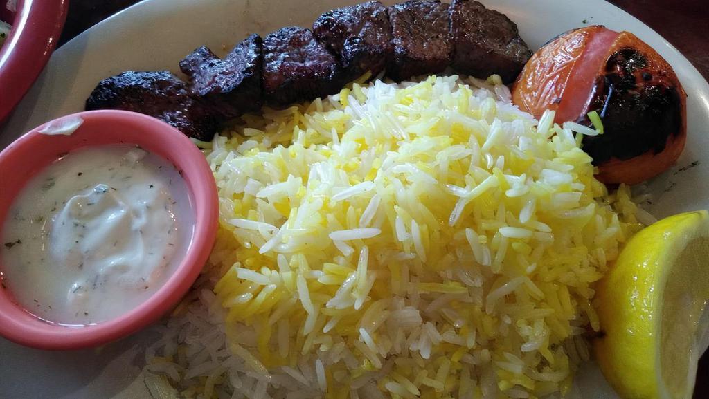 Chenjeh - Steak Kabob · Chenjeh kabob. Medallions chunks of charbroiled beef tender (5 ounces), the meal comes with 1/2 a charred tomato and your choice of rice or bread or salad. Try it with an added koobideh!