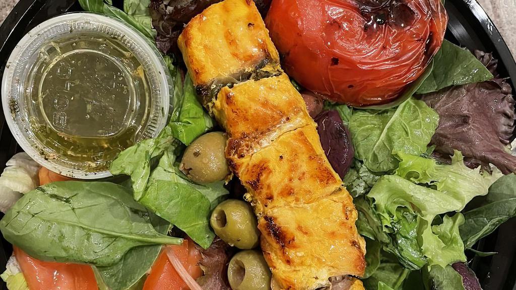 Fish · Norwegian salmon kabob. A skewer meal of charbroiled Norwegian salmon marinated in saffron, organic lemon juice, extra virgin olive oil and babajoon's special spices! Comes with 1/2 a charred tomato and your choice of rice or salad or bread.