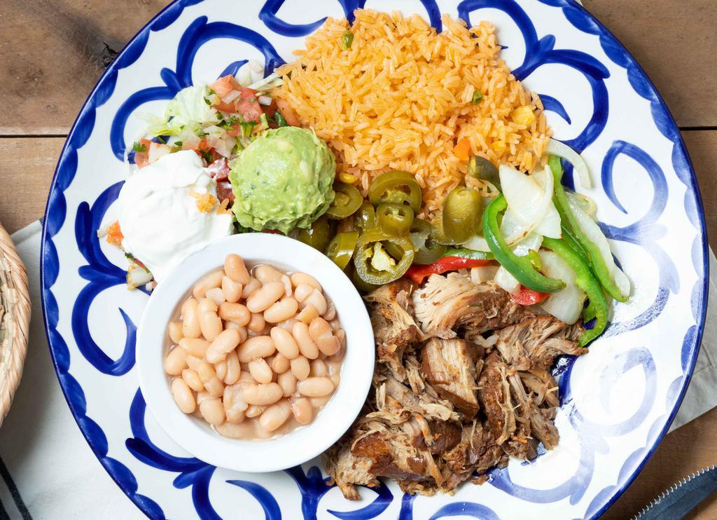 Carnitas Michoacan · Egg free, nut free, gluten-free, soy free, dairy free. Pork shoulder slowly braised in spices. Served with pico de gallo, sautéed onions, peppers, guacamole, and pickled jalapenos.