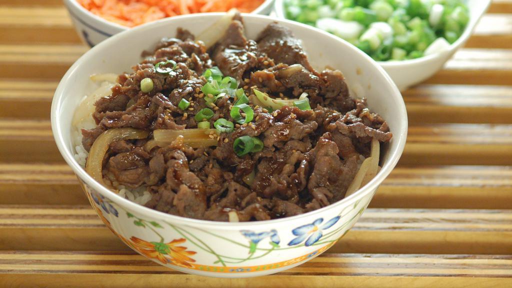 Bulgogi Bowl · Thinly sliced beef in Korean bulgogi marinade, stir fried with onions, topped with sesame seeds and green onions. Served over a bed of rice.