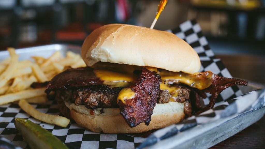 Smoky Burnout Burger · Smoky meats on top of a burger. Bacon, beef brisket, Jameson sauce, and cheddar cheese on top of our signature burger patty.