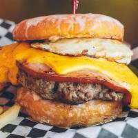Hangover Burger · Last night brought you here! Bacon-wrapped burger patty topped with grilled ham, 2 fried egg...