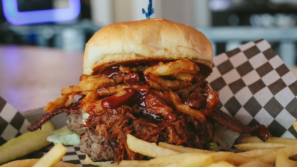 Honky Tonk Burger · Loud and rowdy burger topped with BBQ pork, BBQ sauce, peppered bacon, crispy onion tanglers, Swiss cheese, lettuce, and mayonnaise.