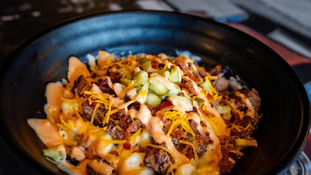 Bacon Cheeseburger Mac & Cheese · Seasoned ground beef, cheddar cheese, bacon bits, and diced pickles drizzled with Sickies’ sauce and served on white cheddar mac & cheese.