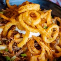 Beef Stroganoff · Mac topped with slow-roasted pot roast, savory brown gravy, mushrooms, fried onion tanglers,...