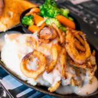 Chicken Fried Chicken Dinner · A generous fresh-fried, crispy chicken fillet topped with country gravy, served with Texas t...